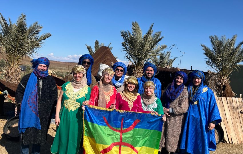 Group of travelers wearing traditional amazigh clothimg, desert day experience